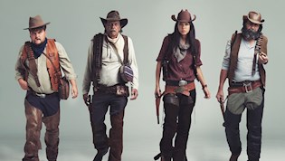 3 men and one woman dressed as cowboys
