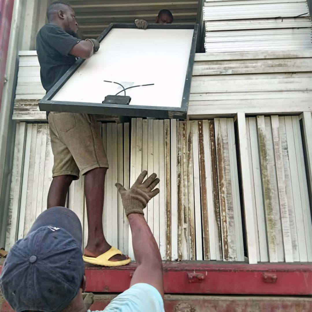 men in Nigeria delivering solahart solar panels